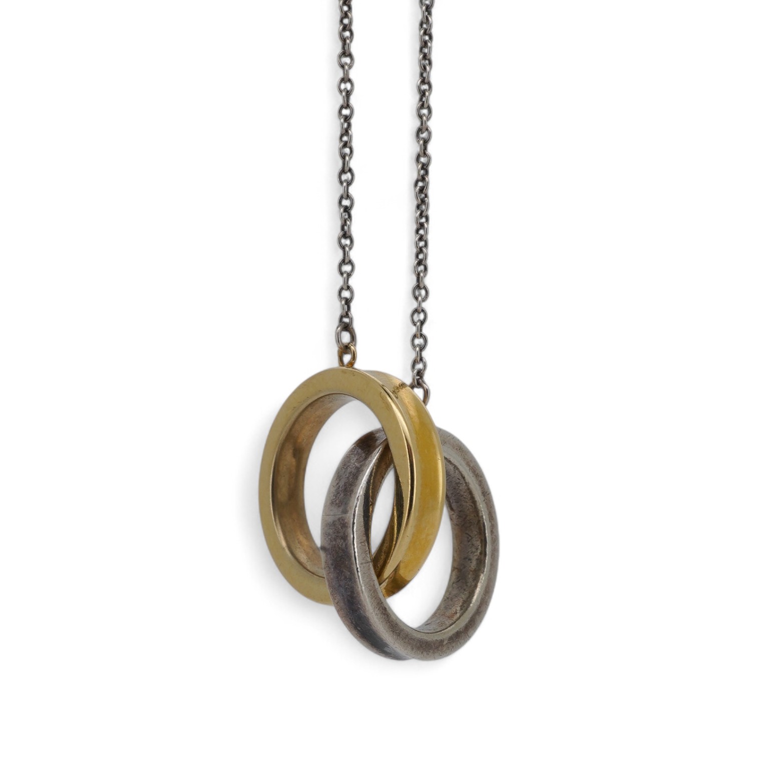 Tiffany & Co., an '1837 Interlocking Circles' pendant necklace, the pendant composed of a pair of interlocking silver and gold rings, to a silver chain, necklace length 47cm, signed T&Co, inscribed 1837, stamped 925 and